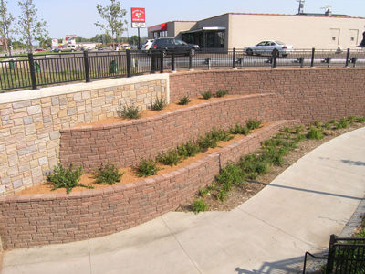 Tiered walls with plantings provide a transition to the tunnel.
